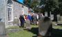 Members of Currie History Society examine a headstone in Currie Kirkyard (June 2011)